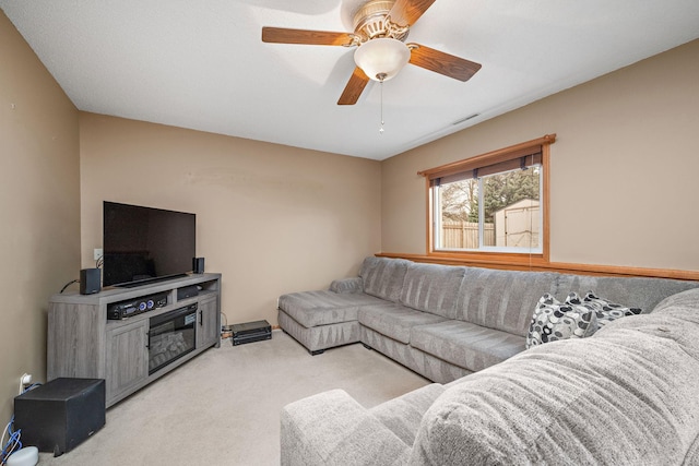 carpeted living room featuring ceiling fan