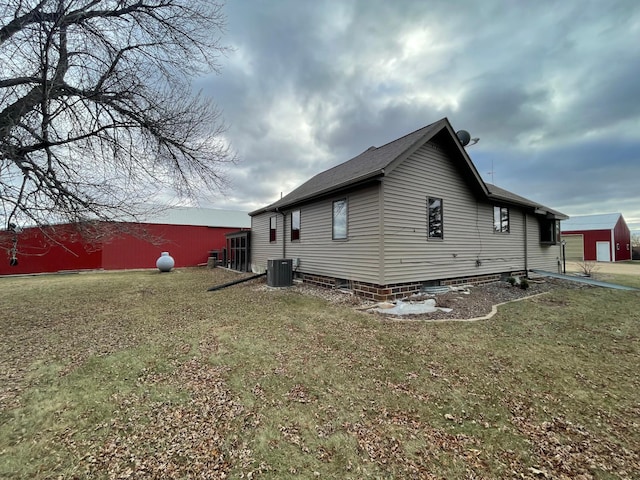 view of home's exterior featuring a yard and cooling unit