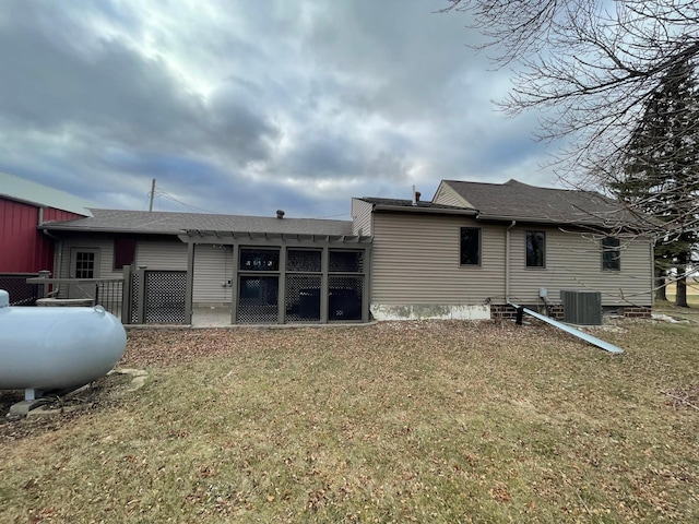 rear view of property with a pergola, cooling unit, and a yard