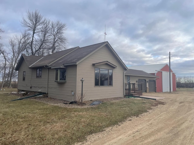 view of side of home with a yard