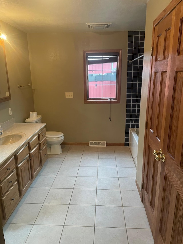 bathroom featuring tile patterned flooring, vanity, and toilet