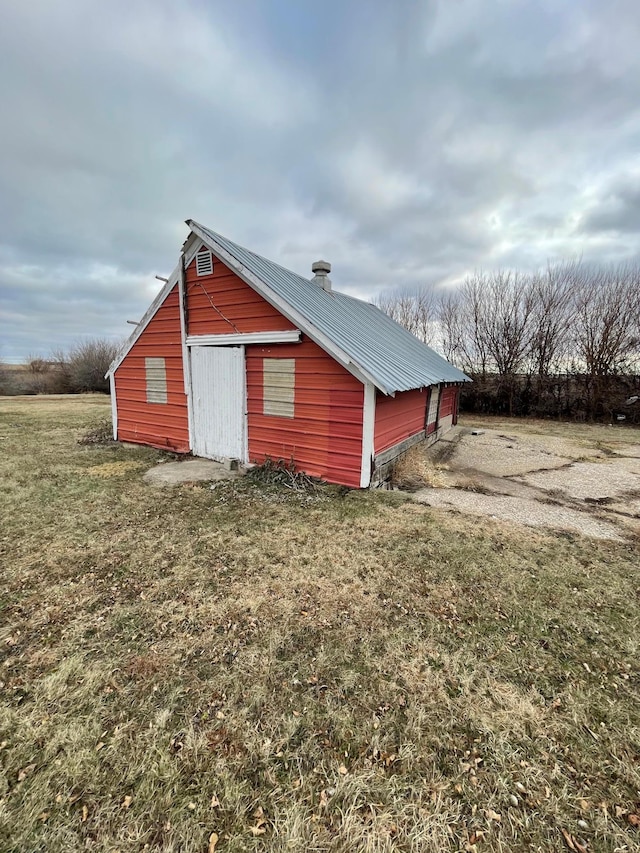 view of outbuilding with a yard