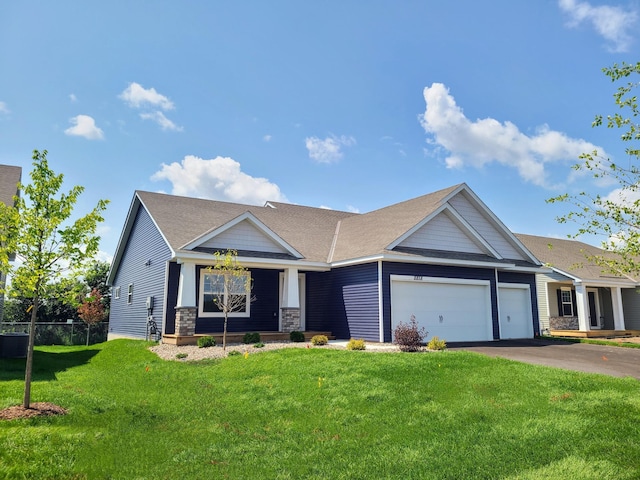 view of front of house featuring a front yard and a garage