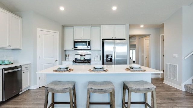 kitchen with a center island, white cabinetry, and stainless steel appliances