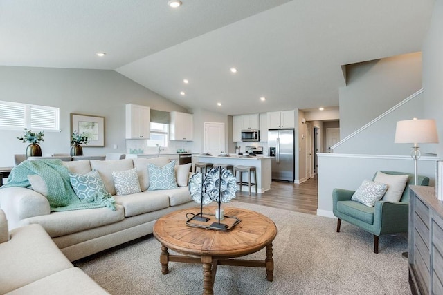 living room with sink and lofted ceiling