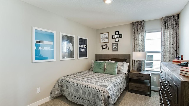 carpeted bedroom with a textured ceiling and multiple windows