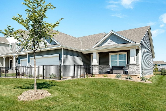 craftsman-style house with covered porch, a front yard, and a garage