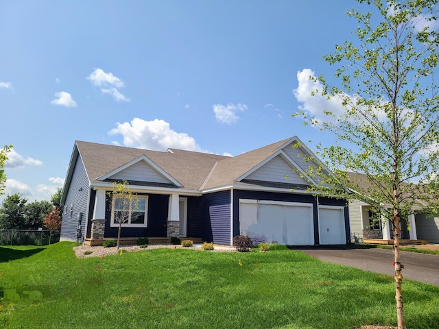 view of front of property with a garage and a front lawn