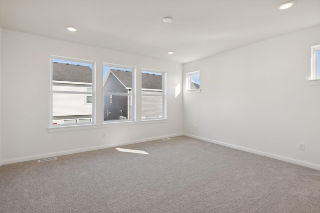 carpeted empty room with a wealth of natural light