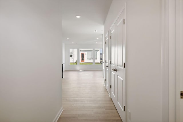 hallway with light hardwood / wood-style flooring