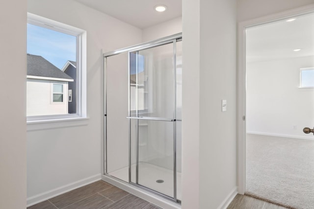 bathroom featuring hardwood / wood-style floors and an enclosed shower