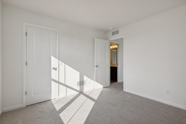 unfurnished room featuring light colored carpet