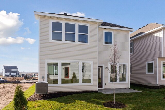 back of house featuring a patio, central AC, and a lawn