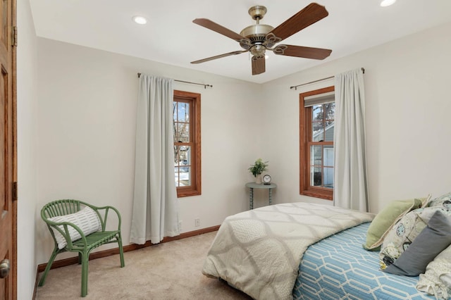 bedroom featuring recessed lighting, multiple windows, light carpet, and baseboards