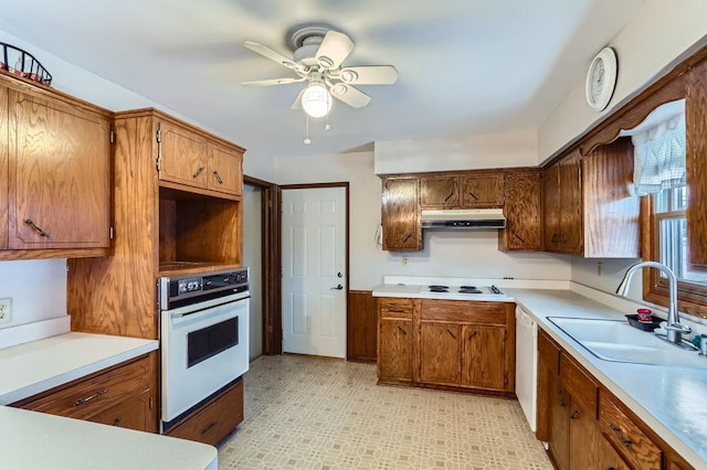 kitchen with ceiling fan, sink, and white appliances