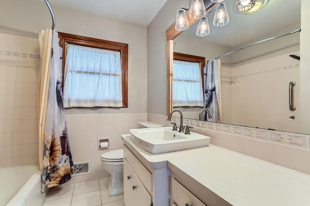 full bathroom with tile patterned flooring, vanity, shower / tub combo, tile walls, and toilet