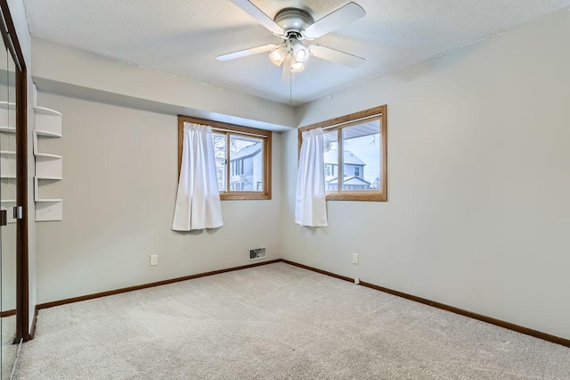 empty room featuring light carpet and ceiling fan