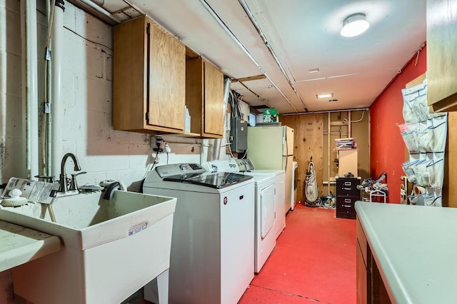 washroom with cabinets, electric panel, washer and clothes dryer, and sink