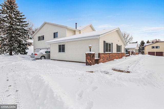 view of snow covered back of property