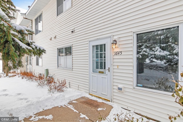 view of snow covered property entrance