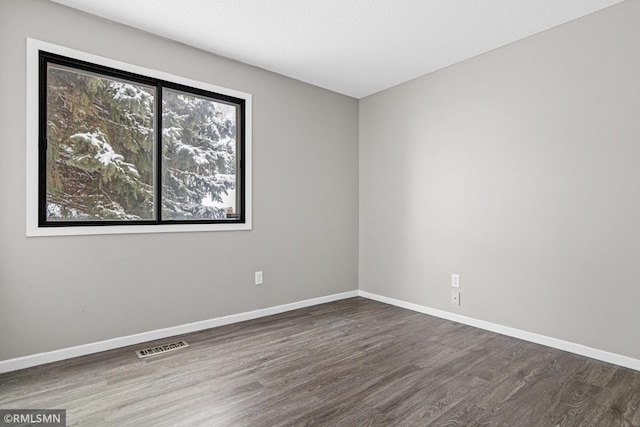 empty room featuring dark wood-type flooring