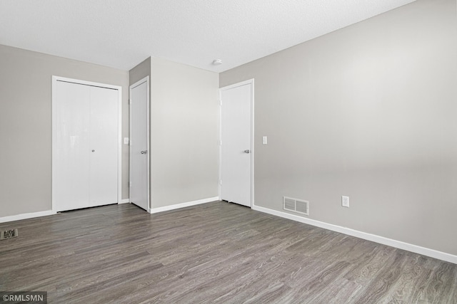 empty room featuring hardwood / wood-style floors and a textured ceiling