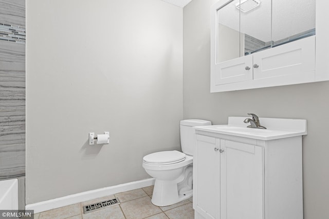 bathroom with tile patterned floors, vanity, toilet, and a textured ceiling