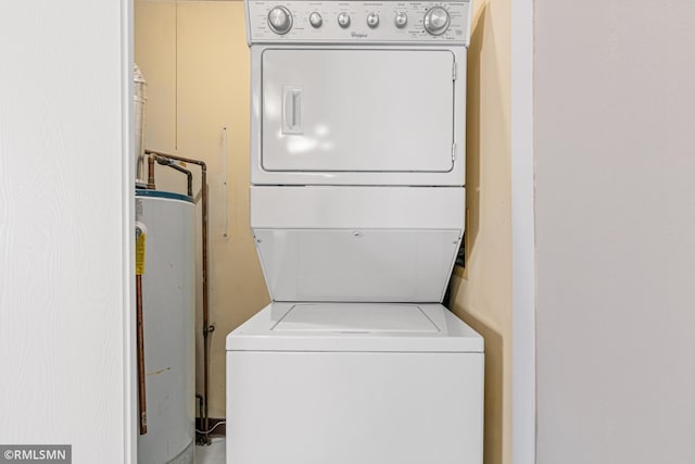 laundry room with stacked washing maching and dryer and water heater