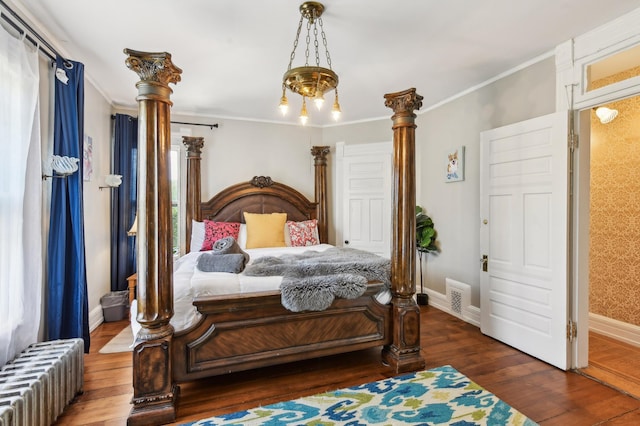 bedroom featuring dark hardwood / wood-style floors, radiator heating unit, and crown molding