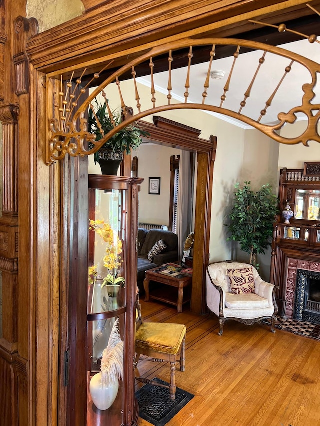 interior space with a fireplace with flush hearth and wood finished floors