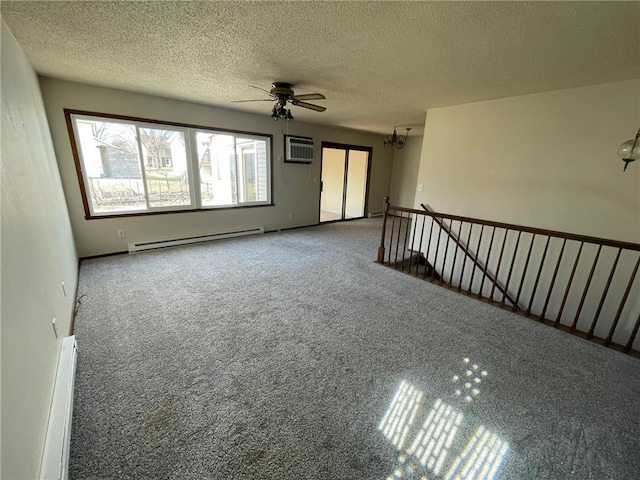 carpeted spare room with ceiling fan with notable chandelier, a textured ceiling, a wall mounted AC, and a baseboard radiator