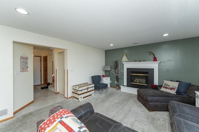 carpeted living room with a textured ceiling