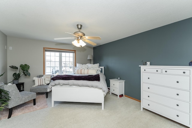 bedroom featuring light carpet and ceiling fan