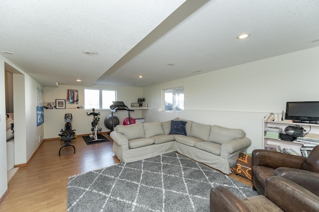 living room featuring wood-type flooring and a textured ceiling