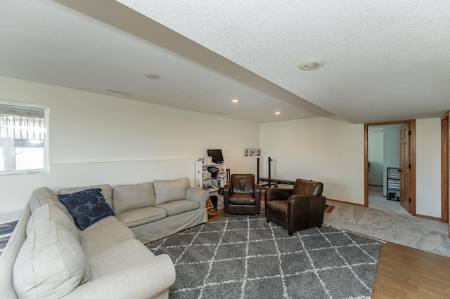 living room featuring dark hardwood / wood-style flooring and a textured ceiling