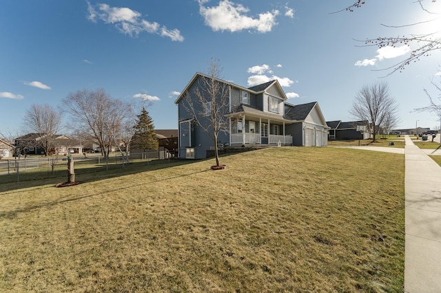 view of side of property with a porch and a lawn