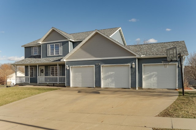 view of front of house with a garage, a front yard, and covered porch