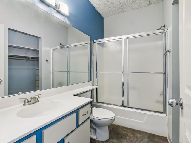 full bathroom featuring toilet, vanity, and combined bath / shower with glass door