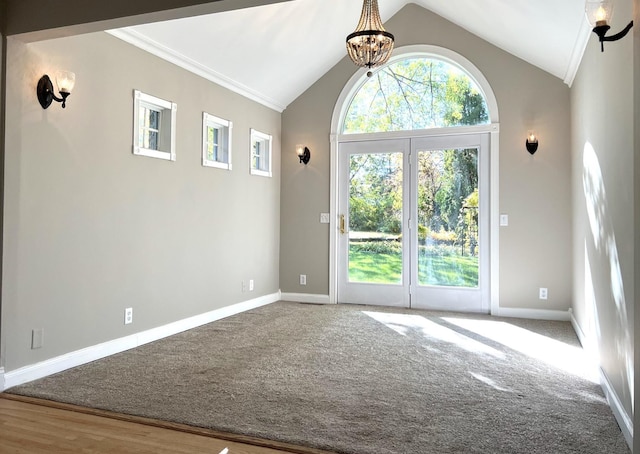 interior space featuring carpet, vaulted ceiling, and a notable chandelier