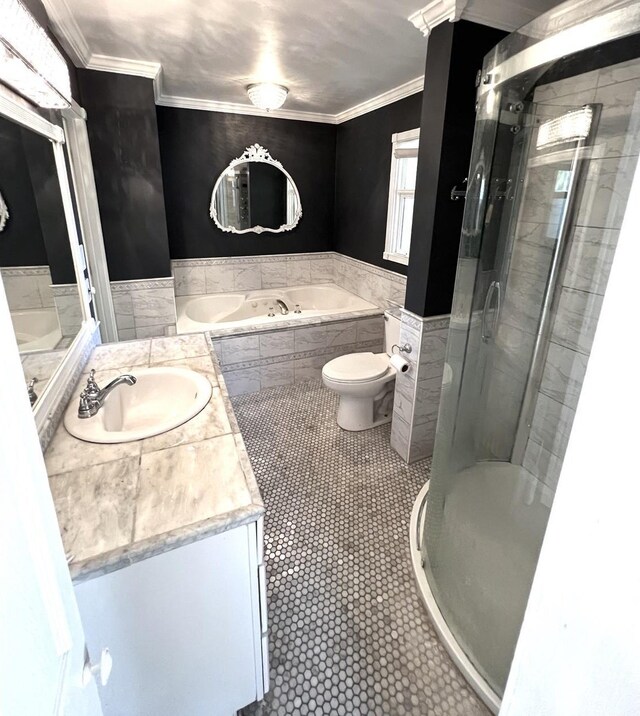 bathroom with tile patterned floors, vanity, crown molding, toilet, and a shower with shower door