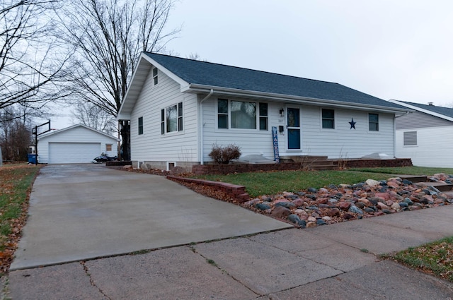 ranch-style house featuring a garage, an outbuilding, and a front yard