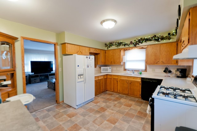 kitchen with white appliances, backsplash, and sink