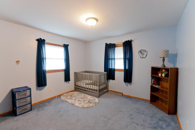 bedroom with carpet and a nursery area