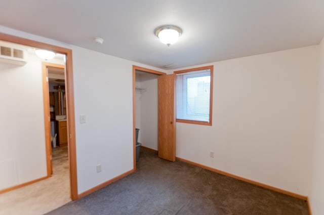 unfurnished bedroom featuring carpet floors and a closet