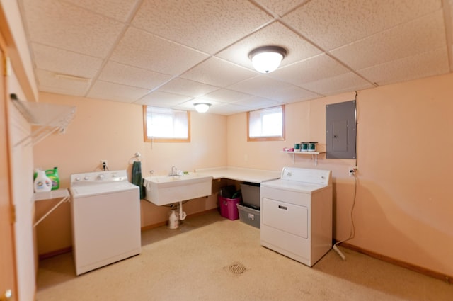 clothes washing area featuring separate washer and dryer, electric panel, light colored carpet, and sink