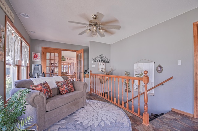 living room with french doors and ceiling fan