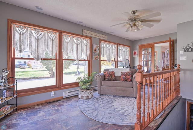 429 Bridge Ave, Warren, MN 56762 - living area featuring a ceiling fan, a textured ceiling, and stone finish floors