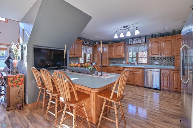 429 Bridge Ave, Warren, MN 56762 - kitchen with appliances with stainless steel finishes, brown cabinets, and healthy amount of natural light