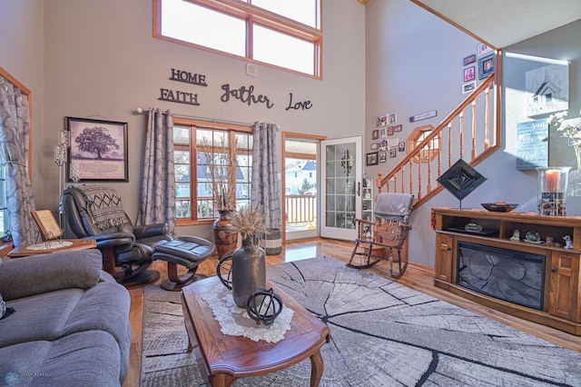 429 Bridge Ave, Warren, MN 56762 - living room with wood finished floors, a high ceiling, and stairs