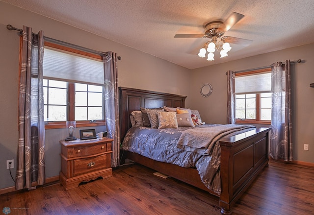 429 Bridge Ave, Warren, MN 56762 - bedroom with dark wood-style floors, a textured ceiling, and a ceiling fan
